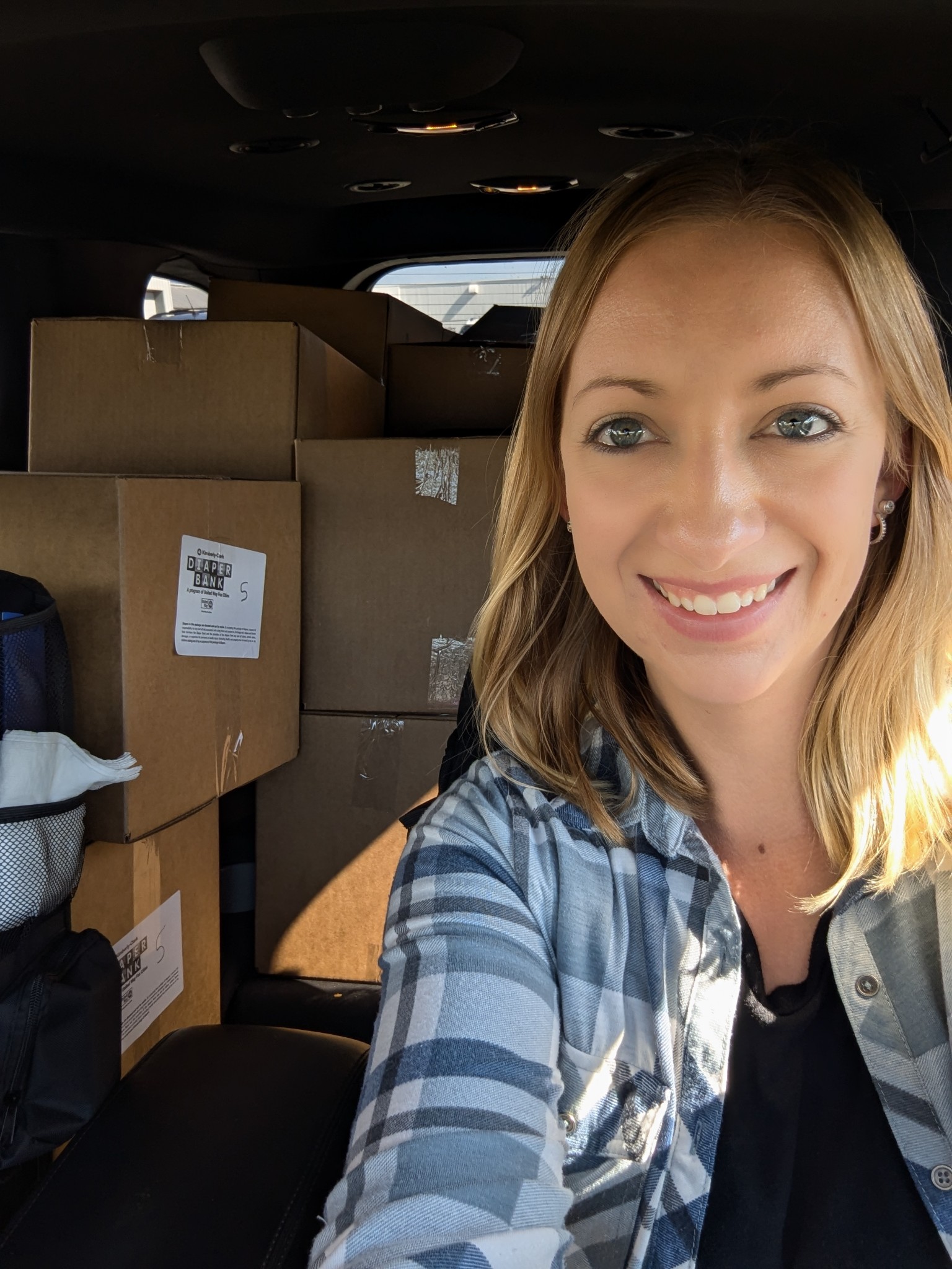 Volunteer transporting boxes of diapers